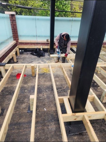 New deck framing being built with pressure-treated lumber