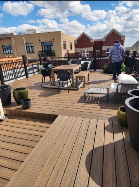 Finished rooftop deck with composite boards, railings, and outdoor seating
